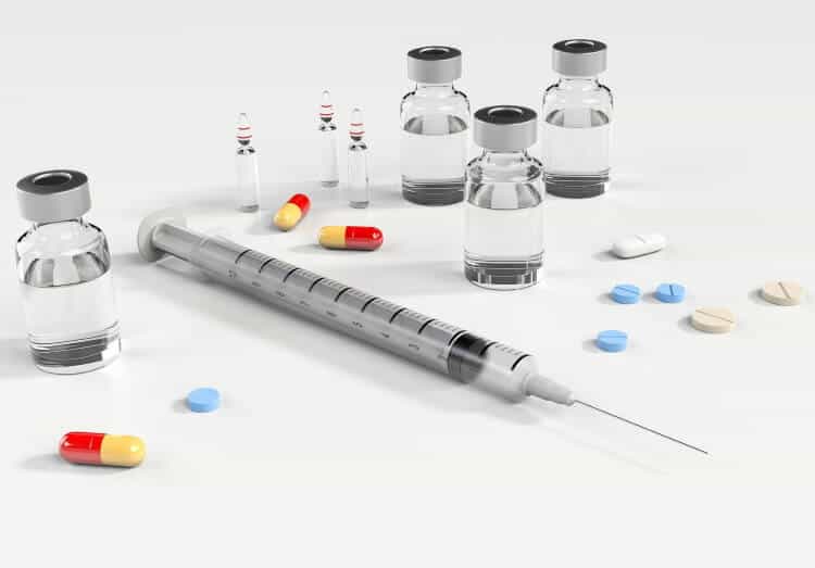 syringe and pills