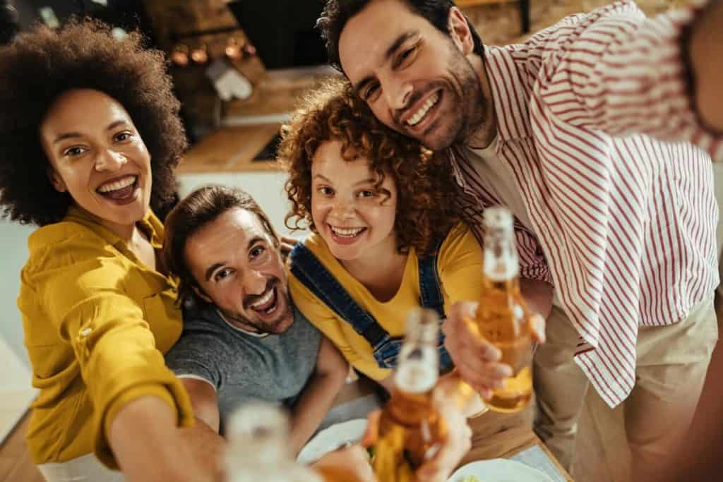 young people drinking beer at home